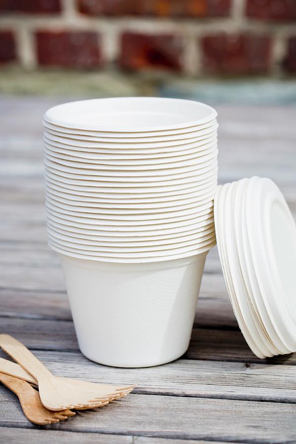 A Stack Of Take-away Cups And Wooden Forks On A Table Outside Photograph by Esther Hildebrandt