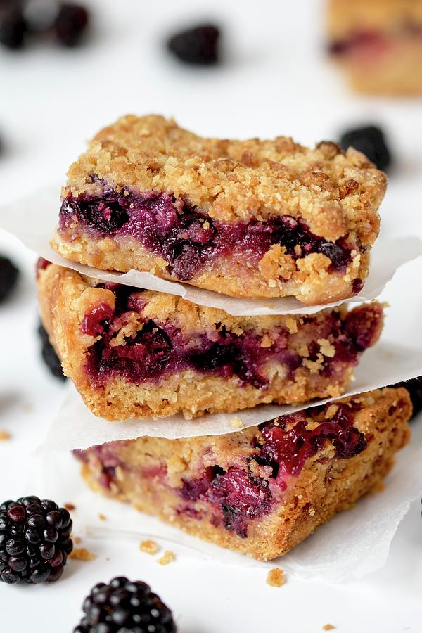 A Stack Of Three Slices Of Blackberry Crumble Photograph by Nicky Corbishley