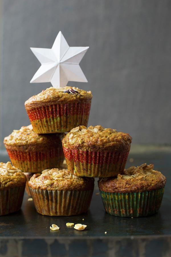 A Stack Of Turmeric Muffins With A Paper Star Photograph by Tina Engel