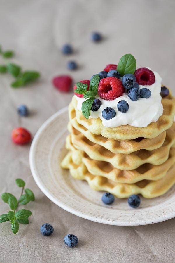 A Stack Of Waffles With Raspberries, Blueberries And Whipped Cream Photograph by Malgorzata Laniak