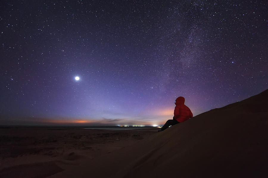 A Stargazer Sitting In The Evening Photograph by Jeff Dai