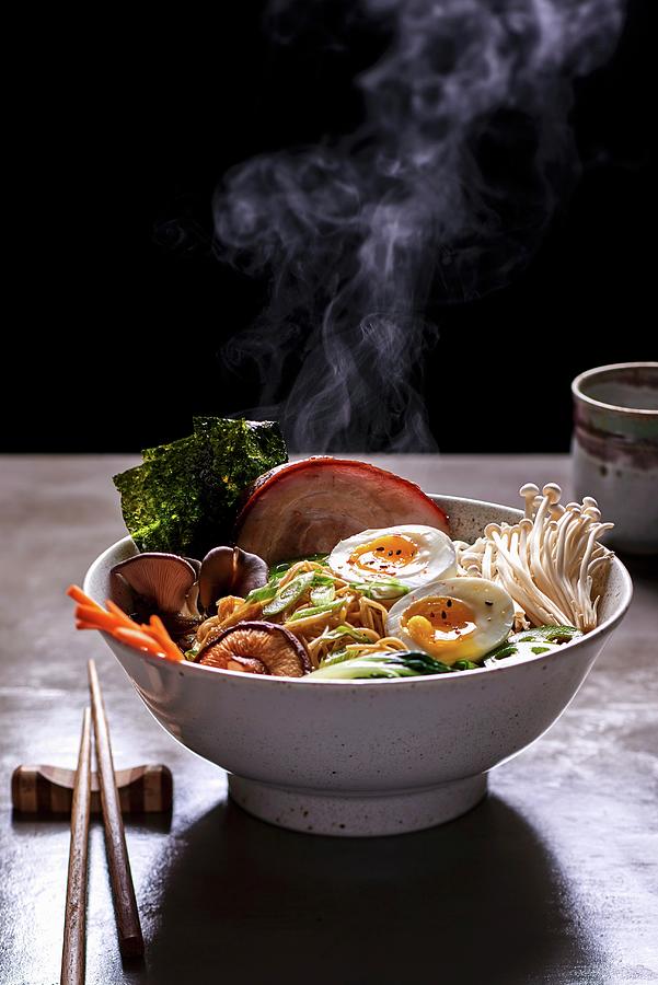 A Steaming Bowl Of Ramen Noodle Soup With Mushrooms, Prawns, Pork Belly And Egg japan Photograph by Fred + Elliott  Photography