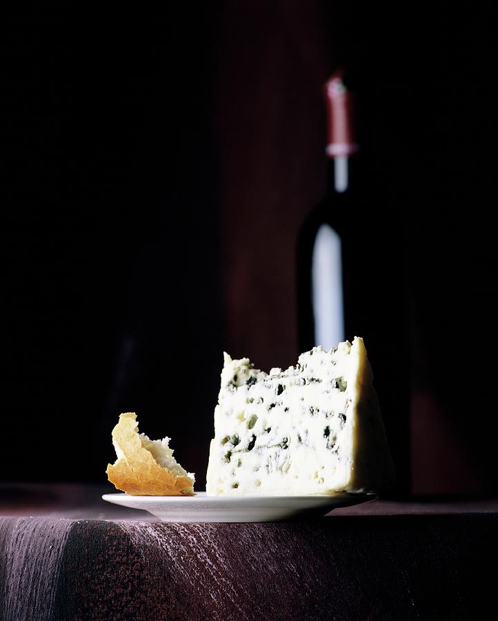 A Still Life Featuring Blue Cheese, Bread And A Bottle Of Red Wine Photograph by Michael Wissing