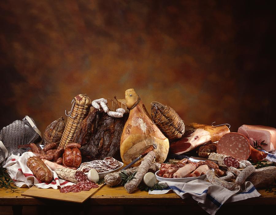 Still Life Photograph - A Still Life With An Assortment Of Italian Hams, Salamis And Sausages by Blueberrystudio