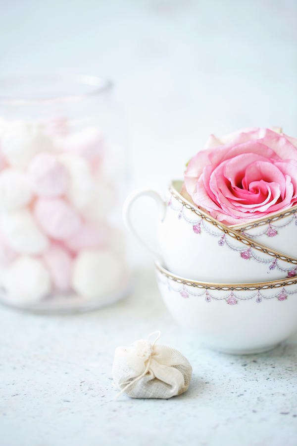 A Still Life With Tea Cups, Rose Petals, Tea Bags And Meringues In A Glass Photograph by Viola Cajo