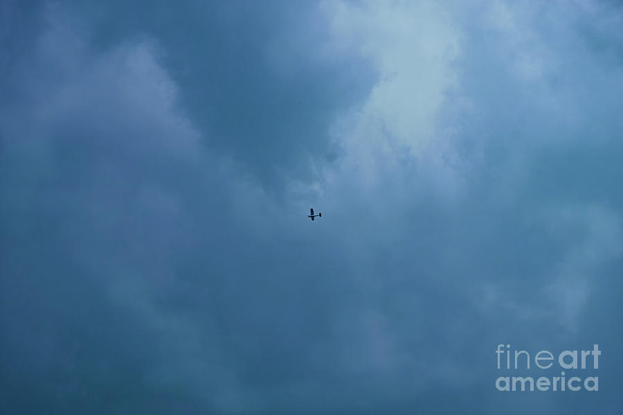 A Stormy Sky And A Little Plane Photograph