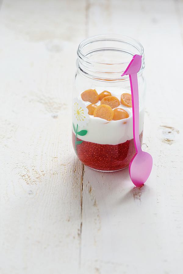 A Strawberry Chia Seed Dessert With Yoghurt And Physalis In A Glass Jar Photograph by Tina Engel