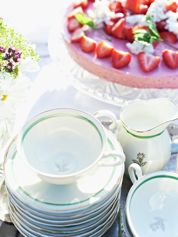 A Strawberry Tart And Teacups On A Garden Table Photograph by Hannah Kompanik