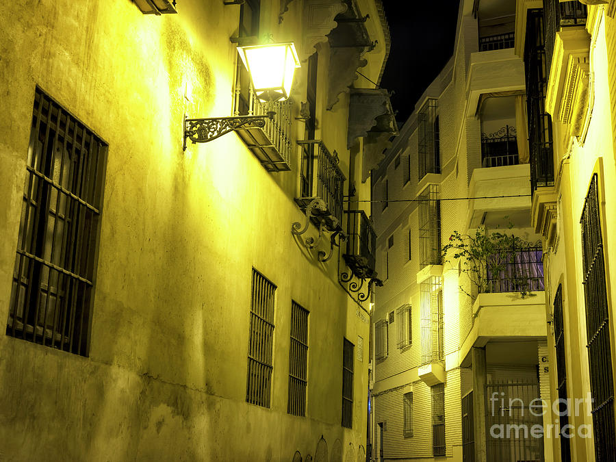 A Street Light in Seville at Night Photograph by John Rizzuto