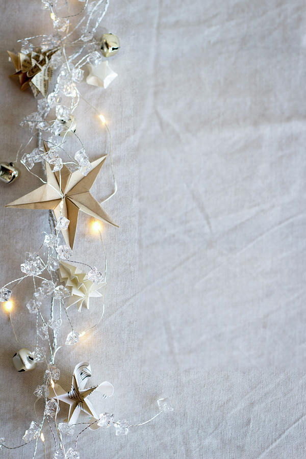 A String Of Fairy Lights With Origami Stars And Origami Fir Trees Photograph by Great Stock!