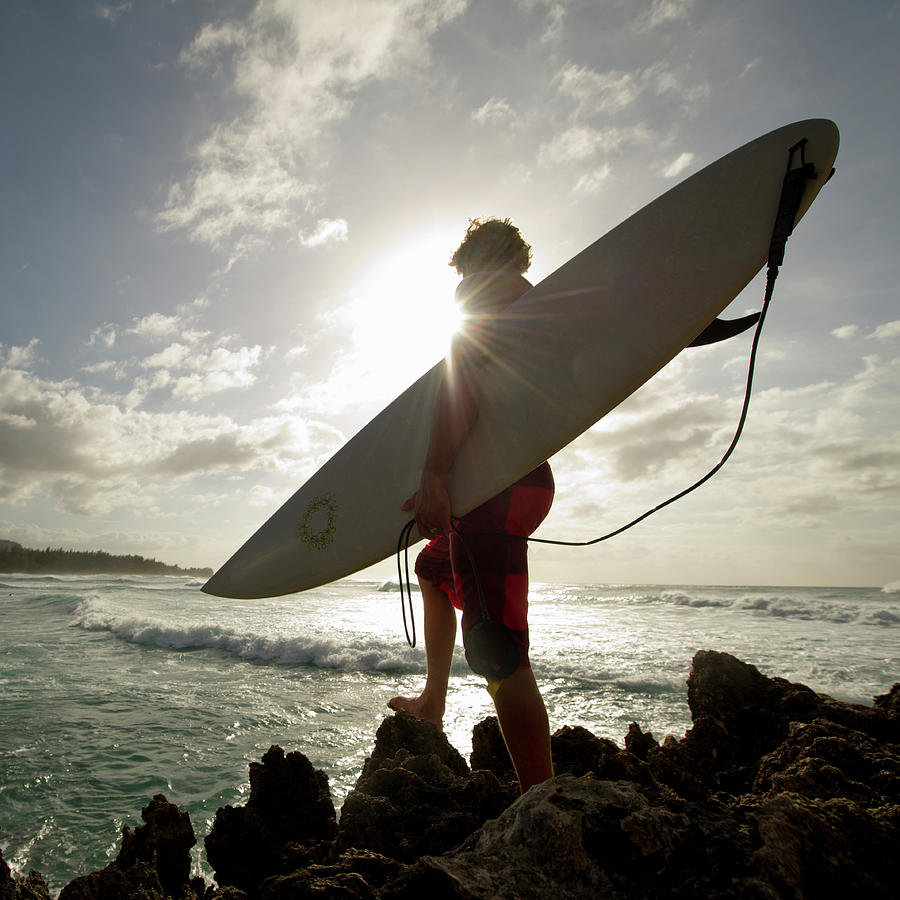A Surfer Stands On A Rock And Looks At Photograph by Noel Hendrickson