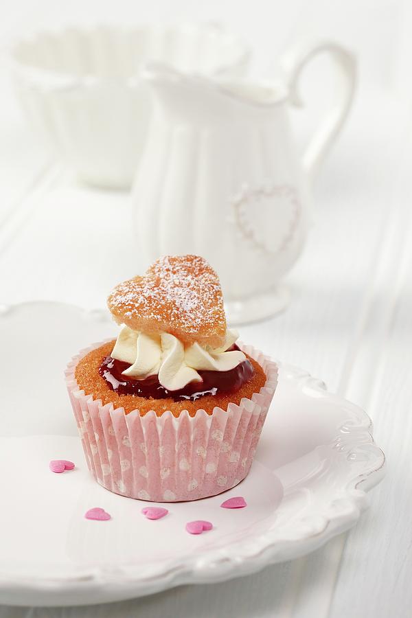 A Sweet Heart Cupcake On A White Plate With White Milk Jug And Sugar Basin In Background Photograph by Stuart Macgregor