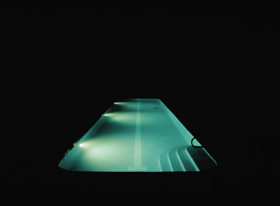 A Swimming Pool Lit At Night Photograph by Frederick Bass