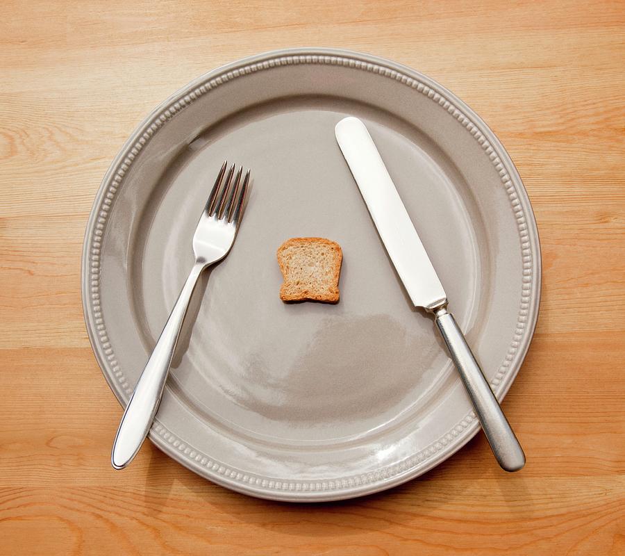 A Symbolic Image For Dieting A Plate With Cutlery And A Tiny Slice Of