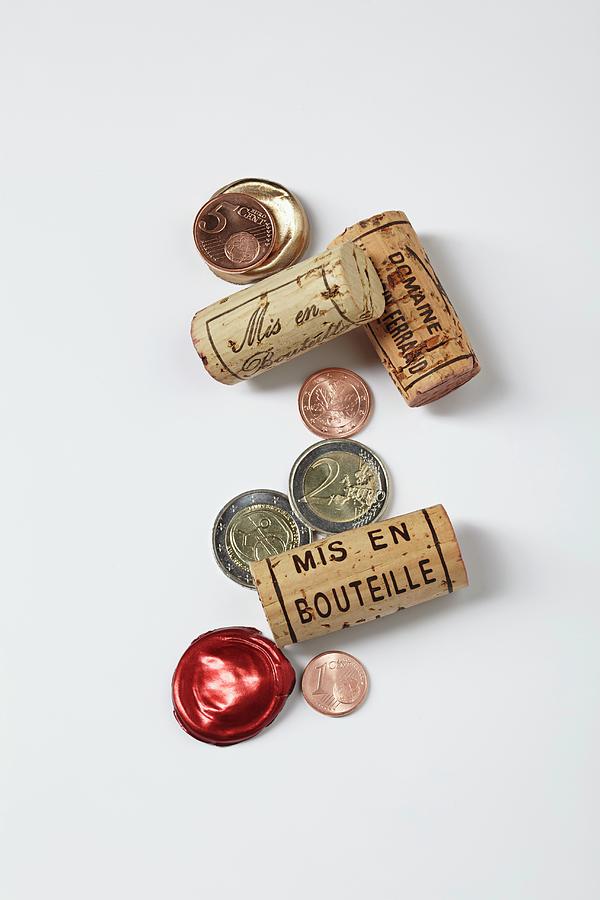 A Symbolic Image Of A Gourmet Investment: Wine Bottle Corks And Money Photograph by Jalag / Gtz Wrage