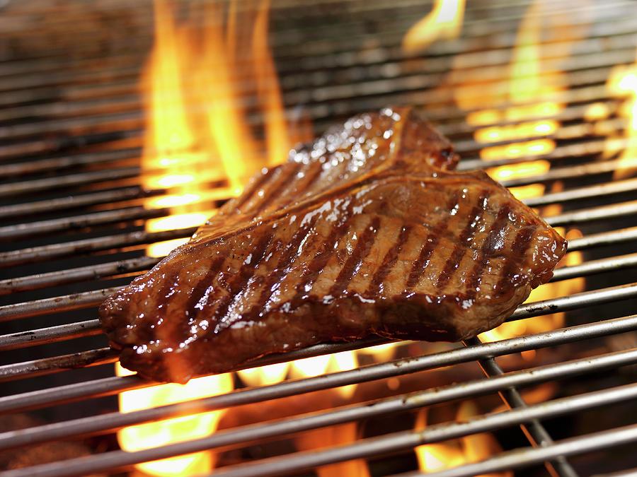A T-bone Steak On A Barbecue Photograph by Ian Garlick