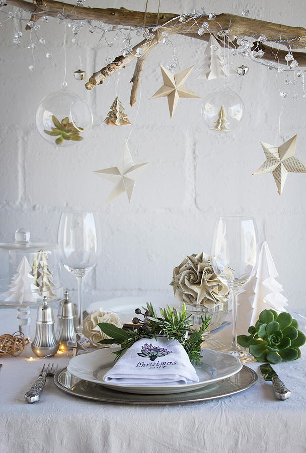 A Table Decorated For Christmas With Paper Decorations And A Napkin Ring Of Herbs Photograph by Great Stock!