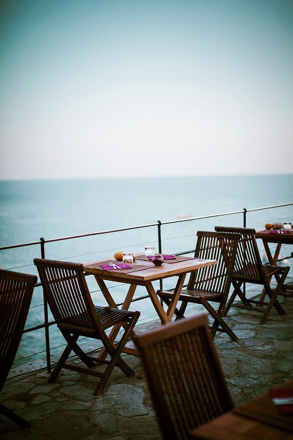 A Table Laid For A Meal On A Terrace At The Seaside Photograph by Alessandra Spairani