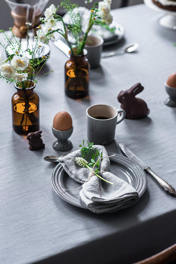 A Table Laid For An Easter Breakfast With A Boiled Egg, Coffee And Chocolate Bunnies Photograph by Carolin Strothe