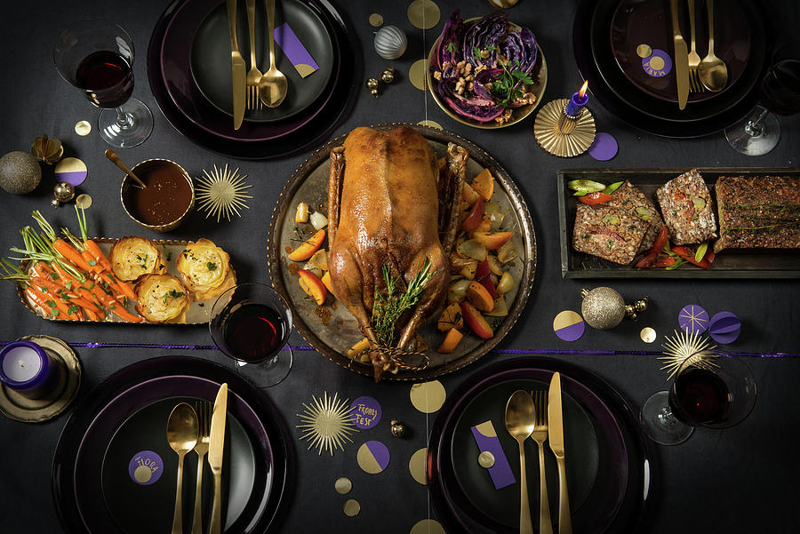 A Table Laid For Christmas With Goose, Vegetarian Nut Loaf, Potato Gratin, Carrots And Red Cabbage Photograph by Fotografie-lucie-eisenmann