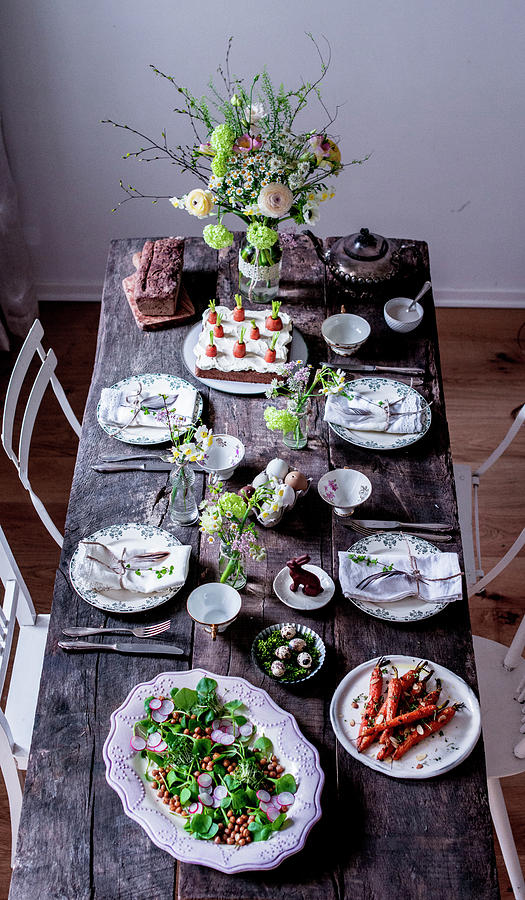 A Table Laid For Easter With A Spring Salad, Roasted Carrots, And Carrot Cake Photograph by Carolin Strothe