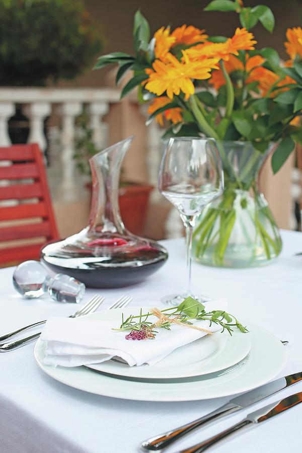 A Table Laid With A White Cloth With A Carafe Of Red Wine And A Bunch Of Orange Flowers Photograph by Great Stock!