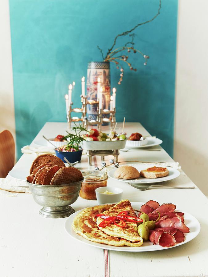 A Table Laid With Pancakes, Ham And Crispbread Photograph by Hannah Kompanik