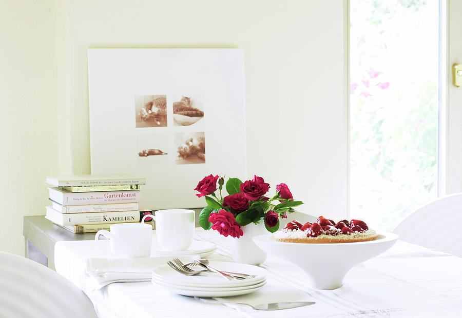 A Table Laid With Strawberry Cake, A Bunch Of Roses, A Coffee Service And Books Photograph by Jeanette Schaun