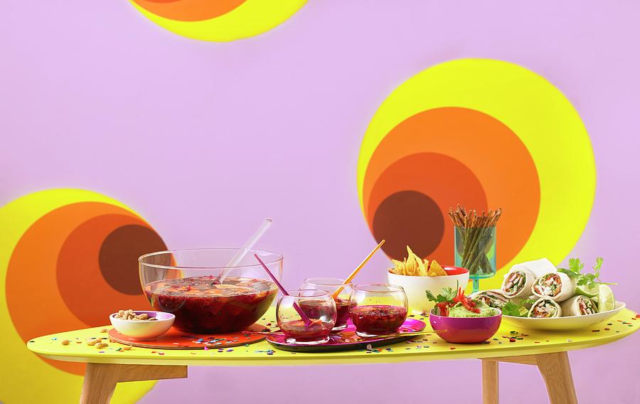 A Table Laid With Wine Punch, Guacamole And Wraps For A Retro Party Photograph by Jan-peter Westermann