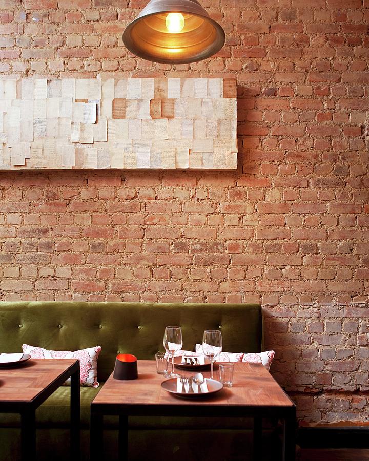 A Table Set For Two In A Restaurant With An Exposed Brick Wall Photograph by Great Stock!
