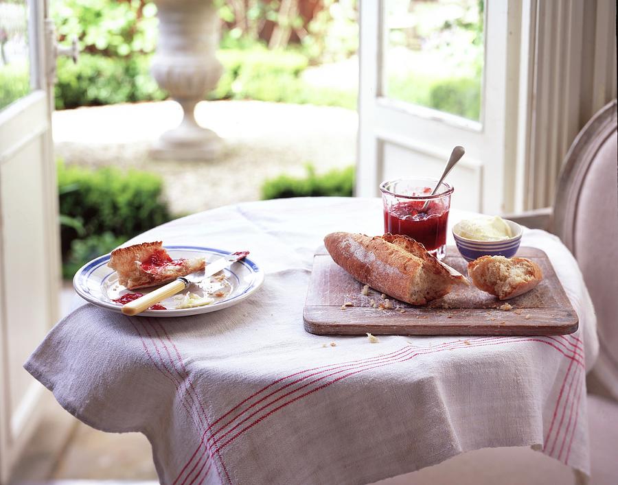 A Table Set With Bread, Jam And Clotted Cream Photograph by Jonathan Gregson