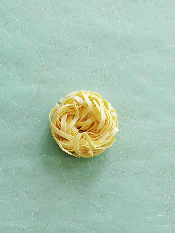 A Tagliatelle Nest On A Textured Background Photograph by Gareth Morgans