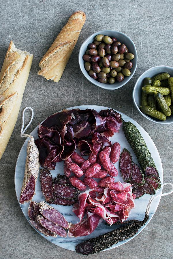 A Tapas Platter With Ham And Sausage Served With Bread, Olives And Cornichons spain Photograph by Justina Ramanauskiene