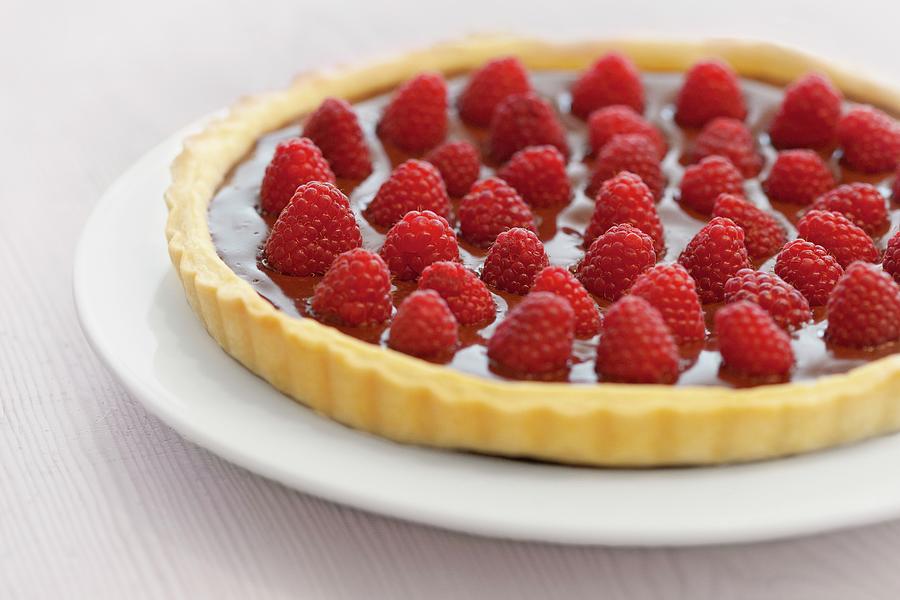 A Tart With A Shortcrust Pastry Base, Topped With Chocolate Cream And Fresh Raspberries Photograph by Jan Wischnewski