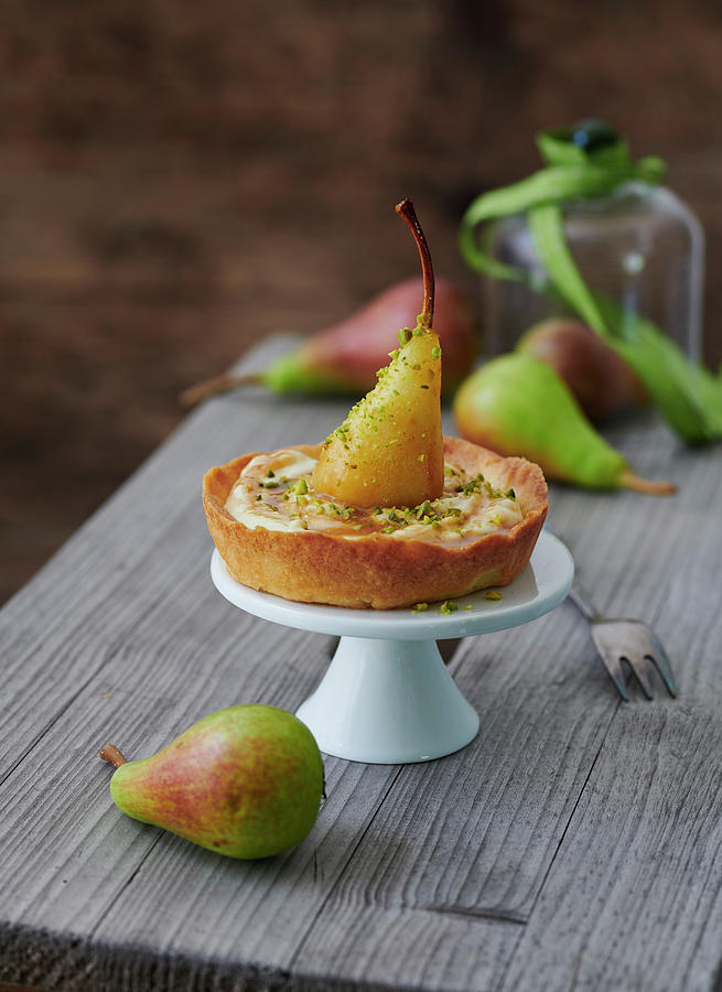 A Tartlet With Braised Mini Pears In Vanilla And Caramel Sauce With Pistachios Photograph by Stefan Schulte-ladbeck