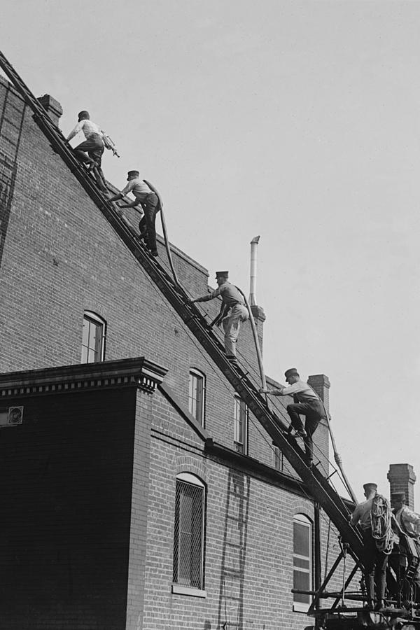 A team of Firefighters with Hoses on Their backs climbs a ladder Painting by Unknown