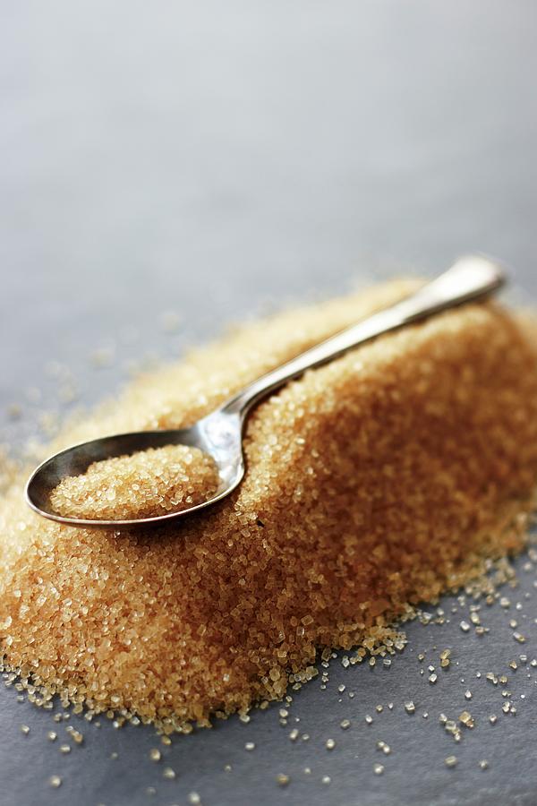 A Teaspoon Laying On A Pile Of Brown Sugar Photograph by Alex Luck