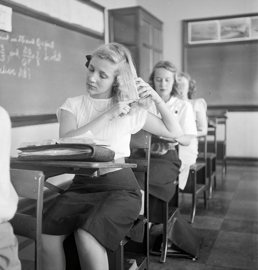 Tulsa Photograph - A teenage girl sitting on a chair and grooming her hair at the Will Rogers high school in Tulsa, OK in 1947. by Nina Leen