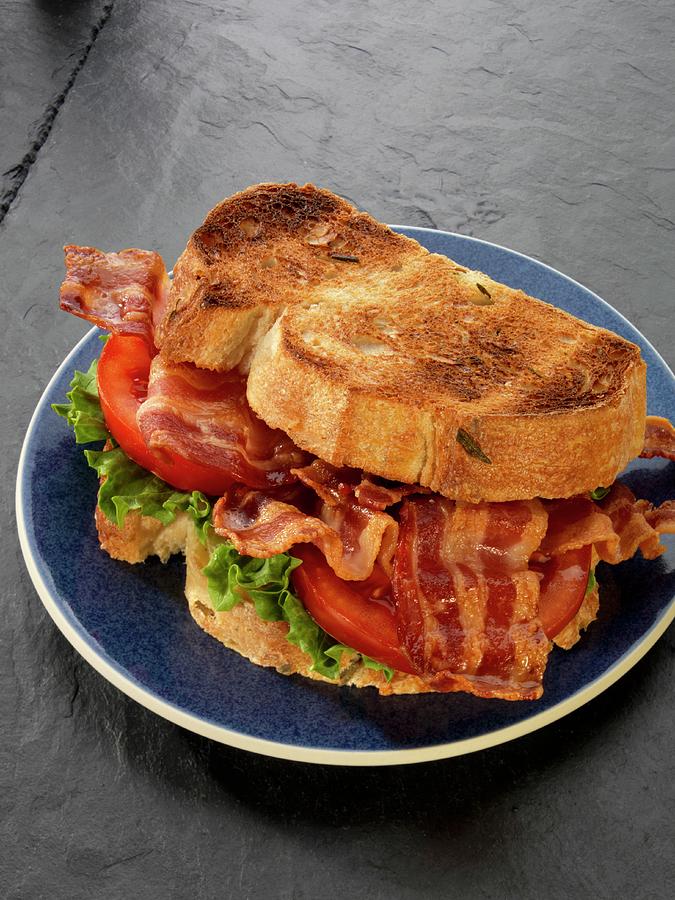 A Toasted Bacon, Lettuce And Tomato Sandwich Photograph by Paul Poplis