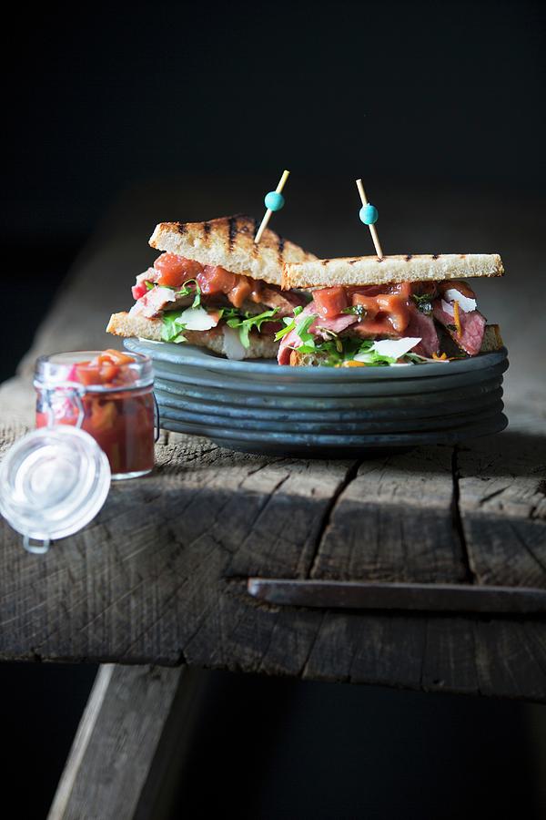 A Toasted Sandwich With Grilled Steak And Rhubarb Chutney On A Wooden Table Photograph by Jalag / Joerg Lehmann