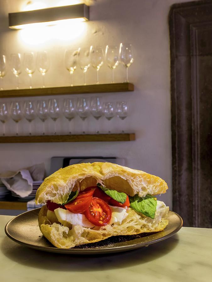 A Tomato, Mozzarella And Basil Sandwich In A Kitchen Photograph by Guy Bouchet