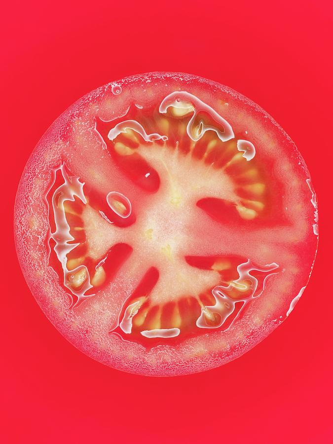 A Tomato Slice On A Red Surface, Close-up Photograph by Oliver Lippert