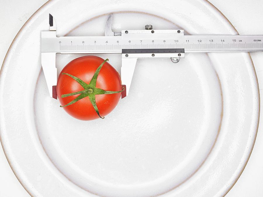 A Tomato With A Precision Ruler Photograph by Clive Streeter