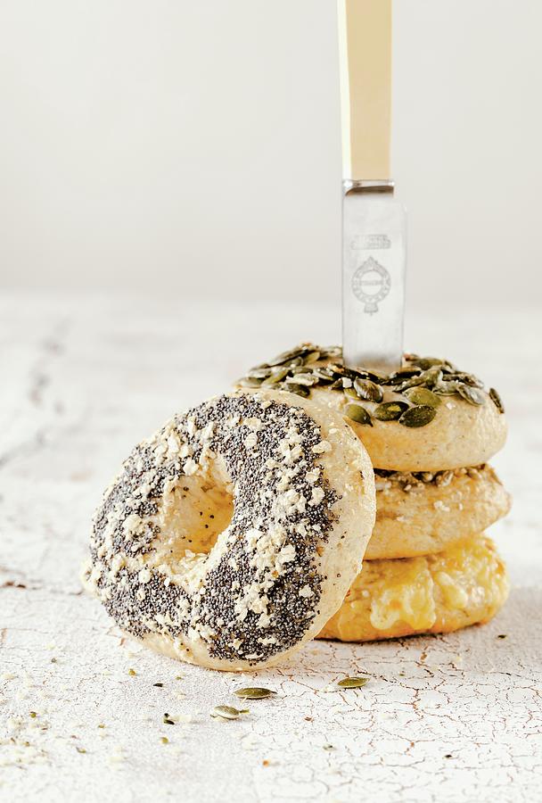 A Tower Of Bagels With A Knife Photograph by Birgit Twellmann