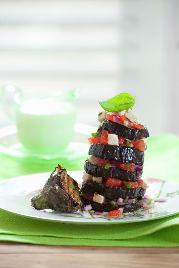A Tower Of Grilled Aubergine Slices With Tomatoes And Feta Photograph by Studio Lipov
