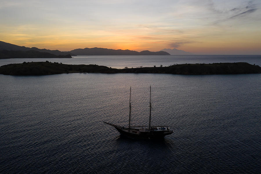 Komodo National Park Photograph - A Traditional Pinisi Schooner Sails by Ethan Daniels
