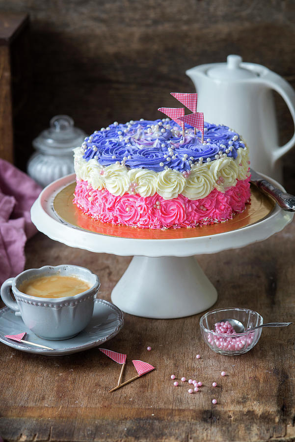 A Tri-coloured Buttercream Cake On A Cake Stand Photograph by Irina Meliukh