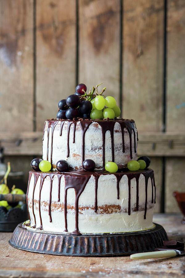 A Two Tier Buttercream Cake With Grapes And A Chocolate Glaze Photograph by Irina Meliukh