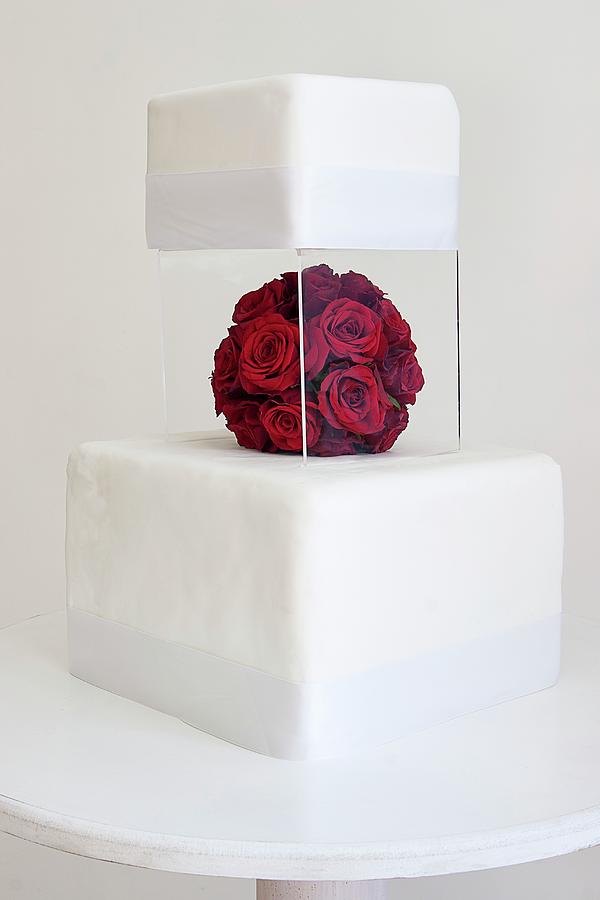 A Two-tier Wedding Cake With A Perspex Stand And Red Rose Decorations Photograph by The Food Union