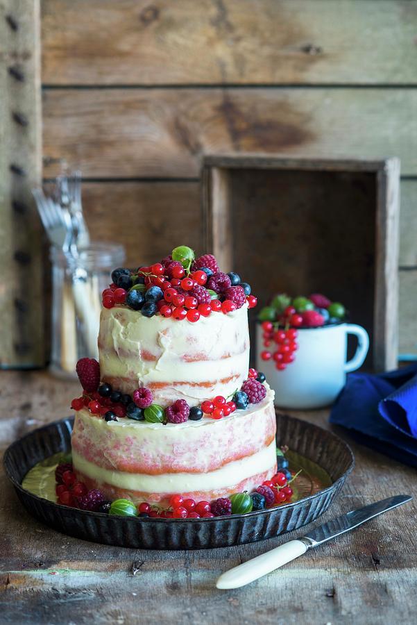 A Two-tiered Semi-naked Cake With Fresh Berries Photograph by Irina Meliukh
